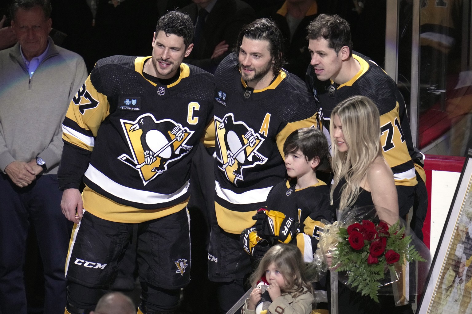 Pittsburgh Penguins&#039; Kris Letang, center, poses for a photo with Sidney Crosby, Evgeni Malkin and his wife Catherine Laflamme, front right, son Alexander, and daughter Victoria, during a pre-game ...
