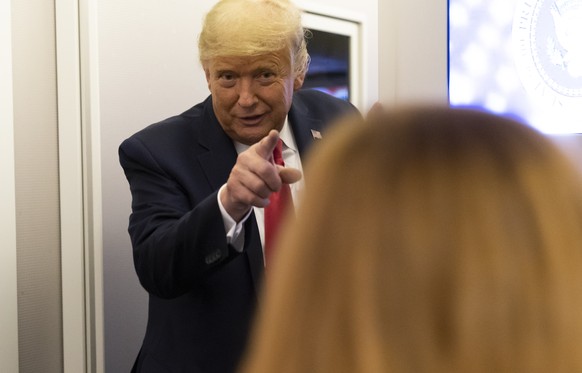 President Donald Trump speaks with reporters while in flight on Air Force One after a campaign rally at Tucson International Airport, in Tucson, Ariz., Monday, Oct. 19, 2020, while en route to Andrews ...