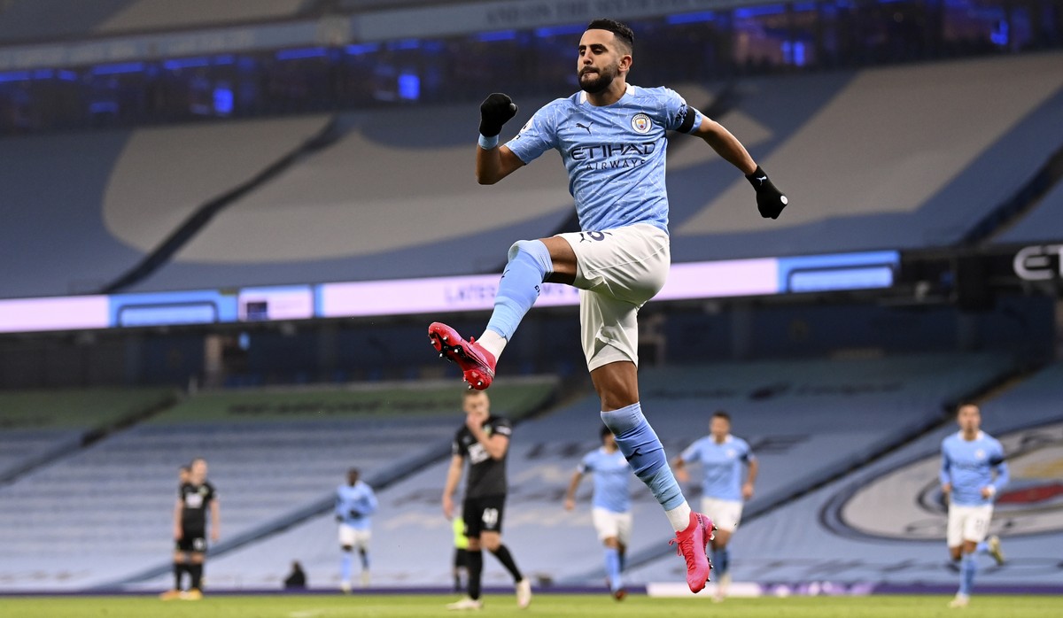 Manchester City's Riyad Mahrez celebrates after scoring his side's opening goal during the English Premier League soccer match between Manchester City and Burnley at the Etihad stadium in Ma ...