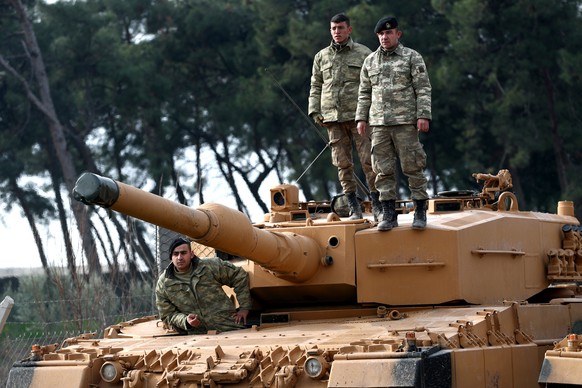 epa06459996 Turkish soldiers prepare their tanks near the Syrian-Turkish border, at Reyhanli district in Hatay, Turkey, 21 January 2018. Reports state that the Turkish army is on an operation (named & ...