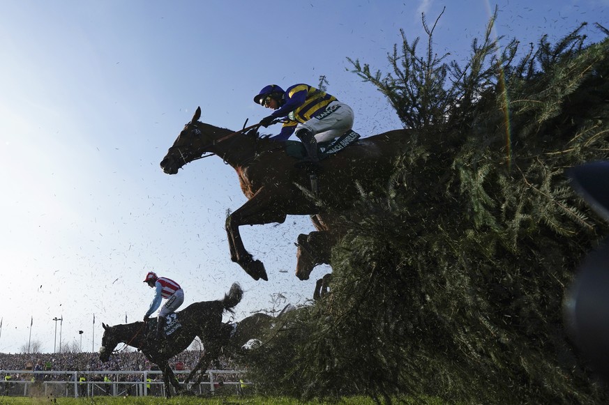 Derek Fox on Corach Rambler, top, clears the Chair fence on the way to winning the Grand National horse race at Aintree Racecourse Liverpool, England, Saturday, April 15, 2023. The iconic Grand Nation ...