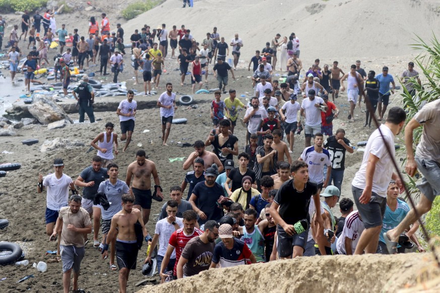 epa13141875 Migrants reach Spanish territory after swimming from Morocco to Ceuta, a Spanish enclave in North Africa, 30 July 2026. Hundreds of migrants swam to cross the border to Ceuta over the last ...