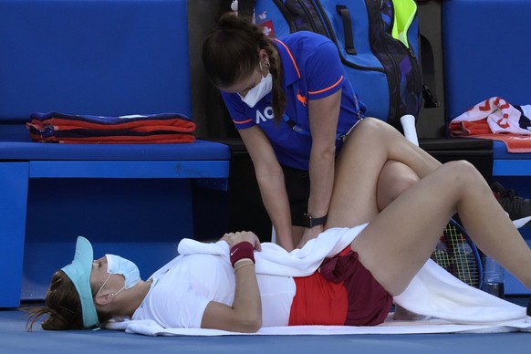 Belinda Bencic of Switzerland receives treatment from a trainer during her second round match against Amanda Anisimova of the U.S. at the Australian Open tennis championships in Melbourne, Australia,  ...