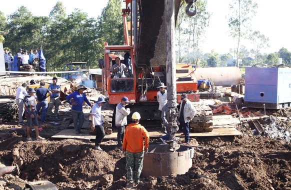 epa10387020 A handout photo made available by the Vietnam News Agency (VNA) shows rescuers at the site where a 10-year-old boy is stuck in a 35-meter deep hole in in Dong Thap Province, Vietnam 03 Jan ...