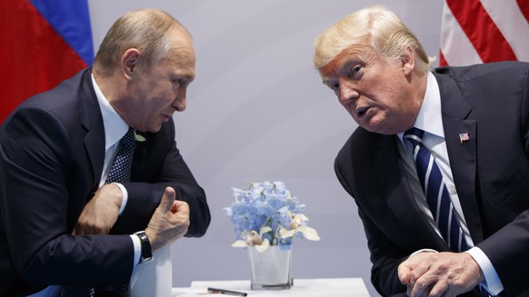 FILE - In this July 7, 2017 file photo, President Donald Trump meets with Russian President Vladimir Putin at the G20 Summit in Hamburg. Putin is more trusted than Trump to do the right thing for the  ...