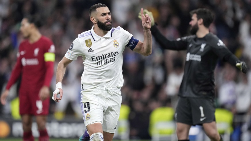 Real Madrid&#039;s Karim Benzema celebrates after scoring his sides first goal during the Champions League, round of 16, second leg soccer match between Real Madrid and Liverpool at the Santiago Berna ...