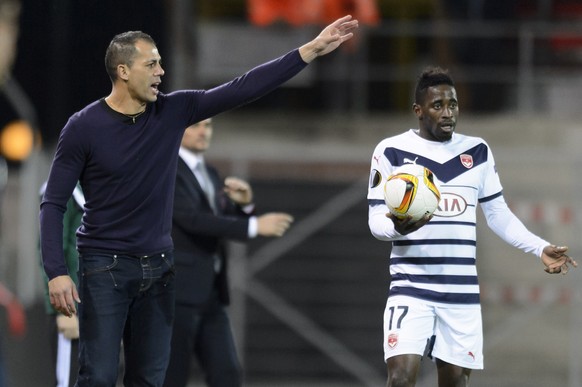Sion&#039;s assistant coach Amar Boumilat, left, gives instructions next to Bordeaux&#039;s Andre Biyogo Poko, right, during the UEFA Europa League group B soccer match between FC Sion and FC Girondin ...