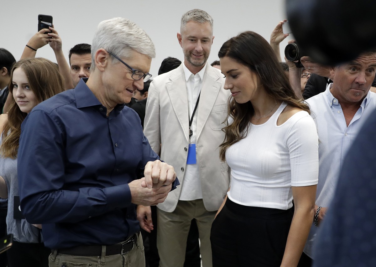 Apple CEO Tim Cook, left and soccer player Alex Morgan discuss the new Apple Watch 4 at the Steve Jobs Theater during an event to announce new products Wednesday, Sept. 12, 2018, in Cupertino, Calif.  ...