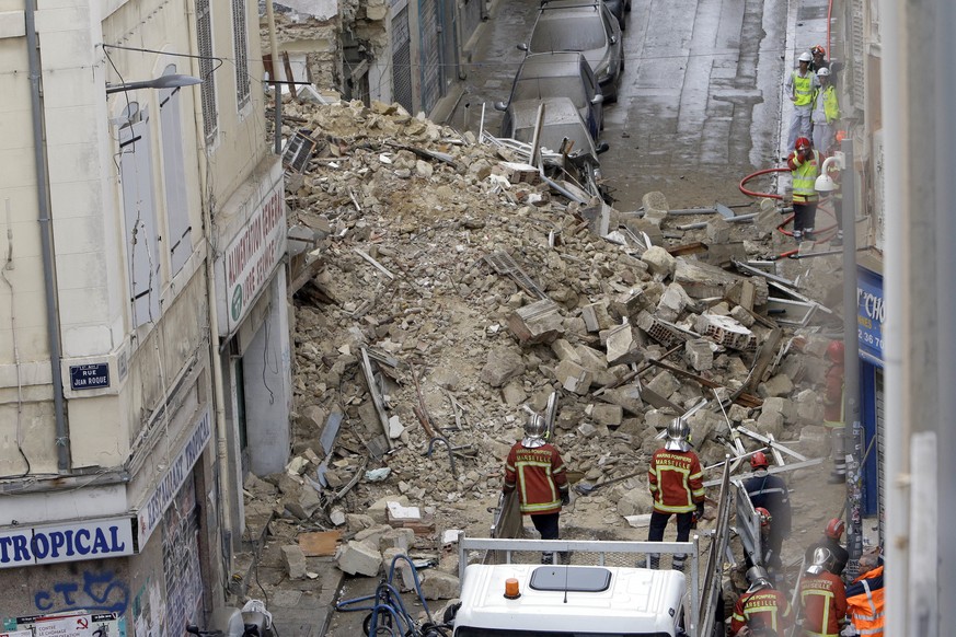 Firefighters work at the scene where buildings collapsed in Marseille, southern France, Monday, Nov. 5, 2018. Two buildings collapsed in the southern city of Marseille on Monday, leaving a giant pile  ...