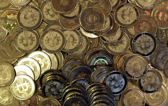 FILE - This April 3, 2013, file photo shows bitcoin tokens in Sandy, Utah. A German software developer who made a fortune from bitcoin has given the environmentalist Greens one of the biggest politica ...