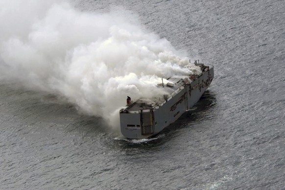 Smoke is seen from a freight ship in the North Sea, about 27 kilometers (17 miles) north of the Dutch island of Ameland, Wednesday, July 26, 2023. A fire on the freight ship Fremantle Highway, carryin ...