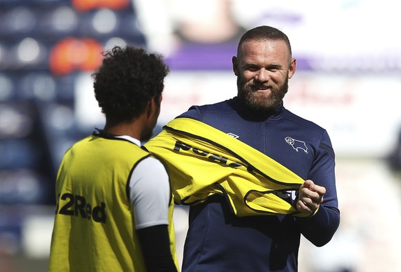 Derby County&#039;s Duane Holmes, left, and Wayne Rooney warm up before their English Championship soccer match against Preston North End at Deepdale, Preston, England, Wednesday, July 1, 2020. (Marti ...