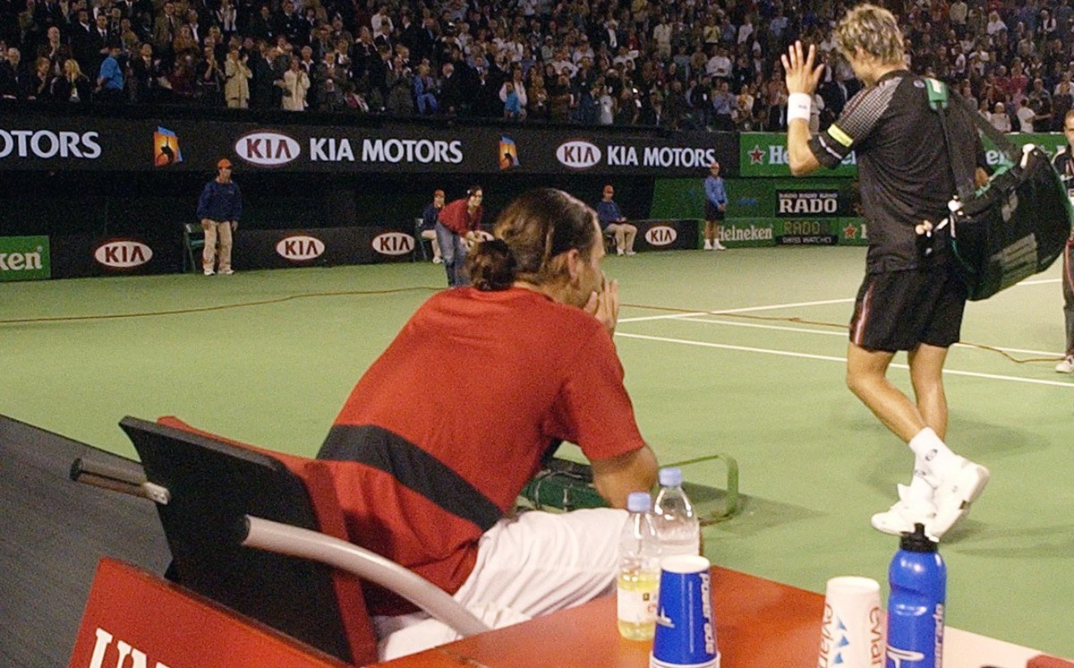 Spain's Juan Carlos Ferrero right, waves as he leaves center following his semifinal loss to Switzerland's Roger Federer at the Australian Open in Melbourne, Australia, Friday, Jan. 30, 2004 ...