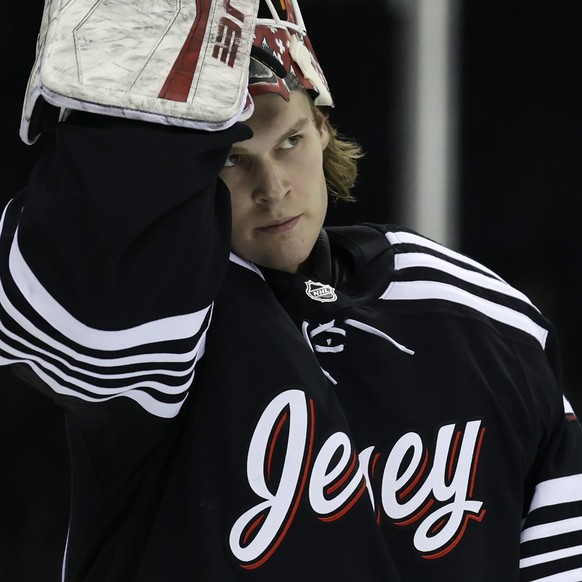 New Jersey Devils goaltender Akira Schmid reacts during the first period of an NHL hockey game against the Dallas Stars Tuesday, Jan. 25, 2022, in Newark, N.J. (AP Photo/Adam Hunger)
Akira Schmid