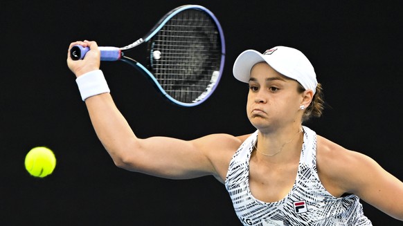 epa09690656 Ashleigh Barty of Australia plays a shot during her first Round Women&#039;s singles match against Lesia Tsurenko of Ukraine on Day 1 of the Australian Open tennis tournament, at Melbourne ...