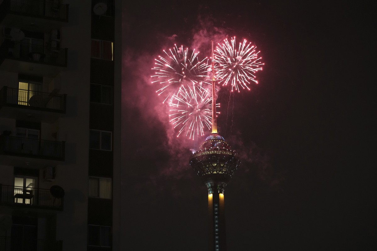 Fireworks explode above Milad telecommunications tower during celebrations marking the anniversary of Iran's 1979 Islamic Revolution, in Tehran, Iran, Friday, Feb. 10, 2023. The government still  ...
