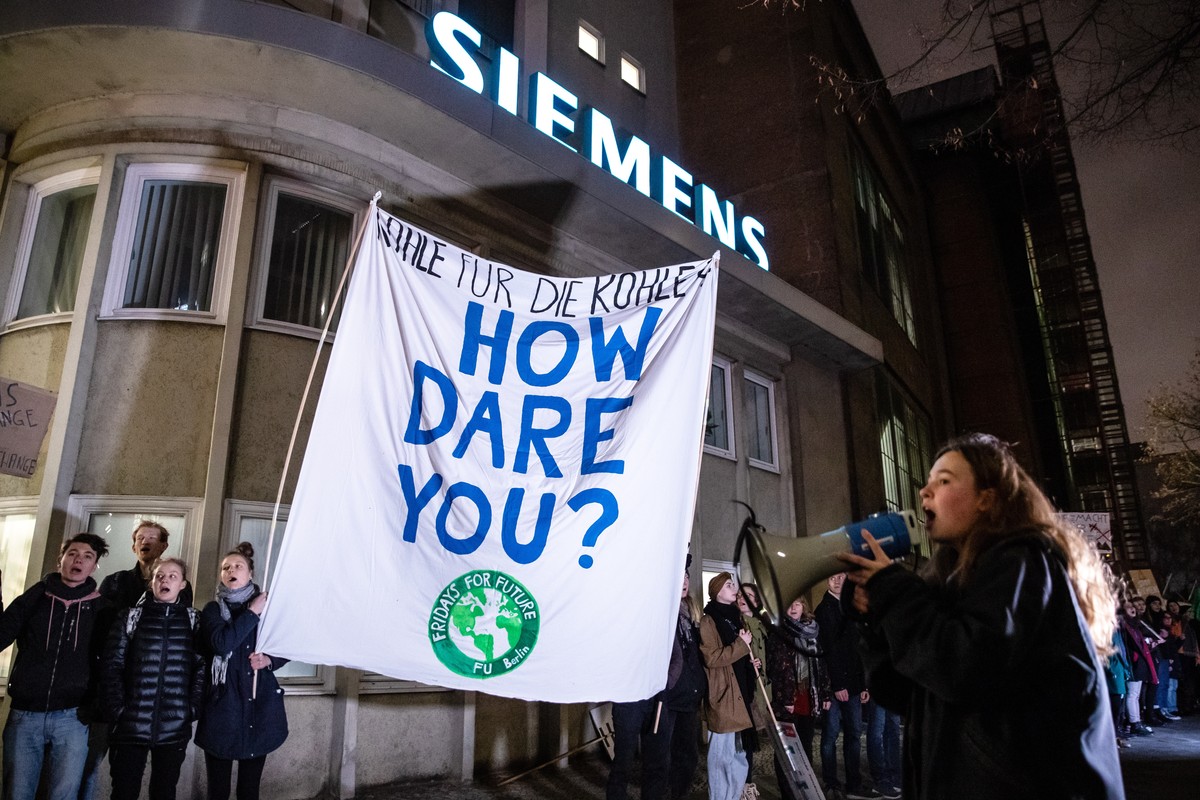 epaselect epa08125408 Fridays For Future activists holding a placard reading 'How dare you?' protest in front of the Siemens AG gas turbine plant in Berlin, Germany, 13 January 2020. The env ...