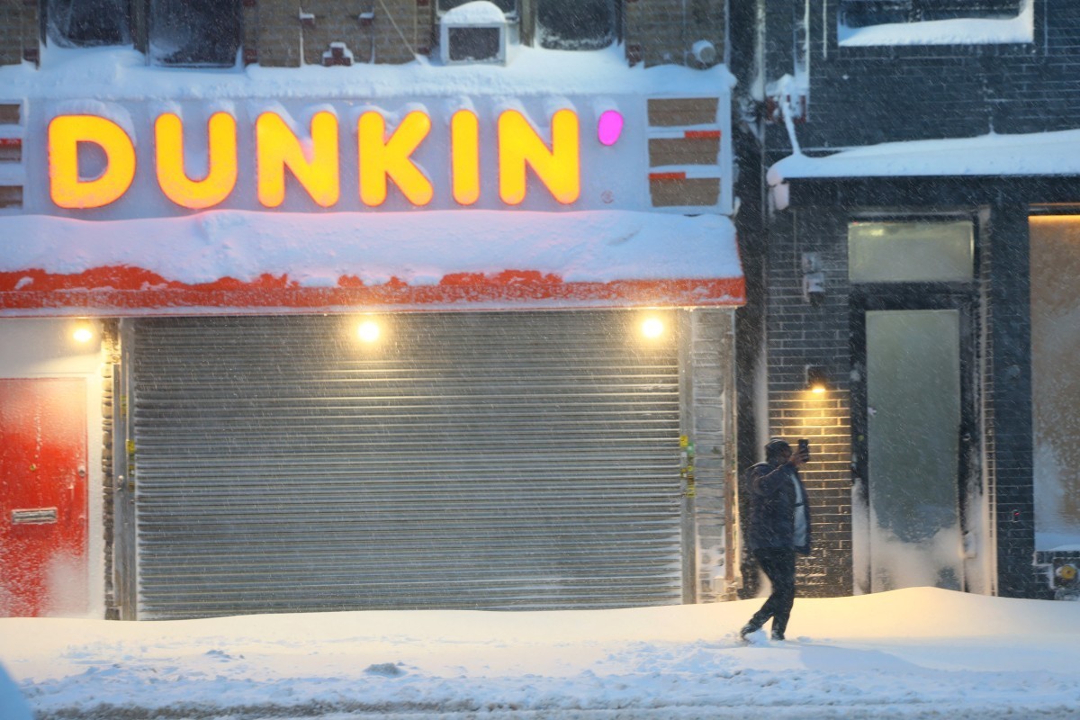 NEW YORK, NEW YORK - FEBRUARY 23: A person records a video as snow falls during a blizzard on February 23, 2026 in the Flatbush neighborhood of the Brooklyn borough in New York City. The northeast U.S ...