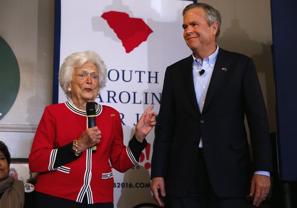 Republican presidential candidate, former Florida Gov. Jeb Bush, listens as his mother, former first lady Barbara speak during a campaign stop at Wade&#039;s Restaurant, Friday, Feb. 19, 2016 in Spart ...