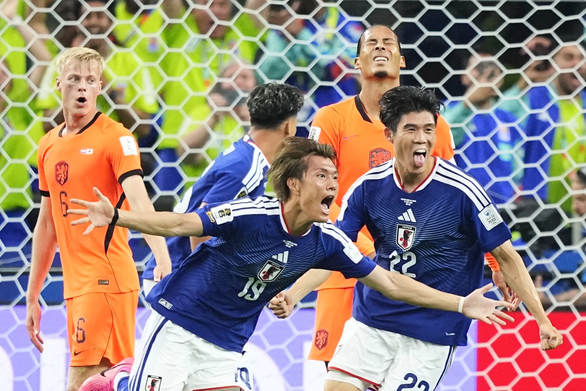 Japan's Koki Ogawa (19) and Takehiro Tomiyasu (22) celebrate their side's second goal against the Netherlands during a World Cup Group F soccer match in Arlington, Texas, near Dallas, Sunday ...