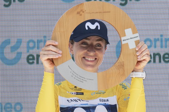 Overall winner Moviestar Team racer Marlen Reusser of Switzerland poses with the trophy on the podium after the fourth and final stage, a 129.4 km race with start and finish in Kuessnacht, Switzerland ...
