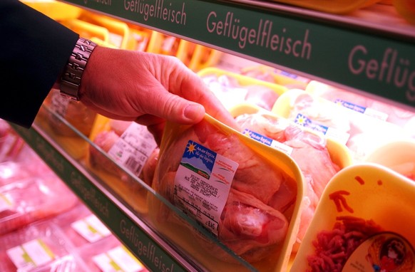A shopper looks at prepacked (none Chinese) chicken in a Swiss supermarket in Lucerne, Switzerland, February 27, 2002. Switzerland disposed an immediate import stop to Chinese chicken after health lab ...