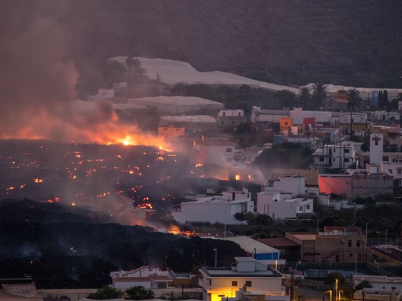 Lava flows from a volcano destroying houses at La Laguna neighbourhood on the Canary island of La Palma, Spain on Thursday Oct. 21, 2021. A second tongue of lava is expected to reach the Atlantic toda ...