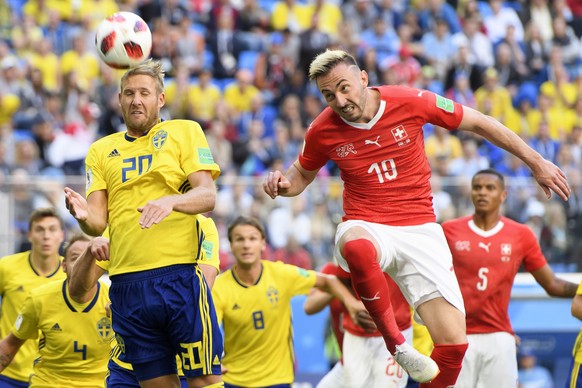 Sweden&#039;s forward Ola Toivonen, left, fights for the ball with Switzerland&#039;s forward Josip Drmic, right, during the FIFA World Cup 2018 round of 16 soccer match between Sweden and Switzerland ...