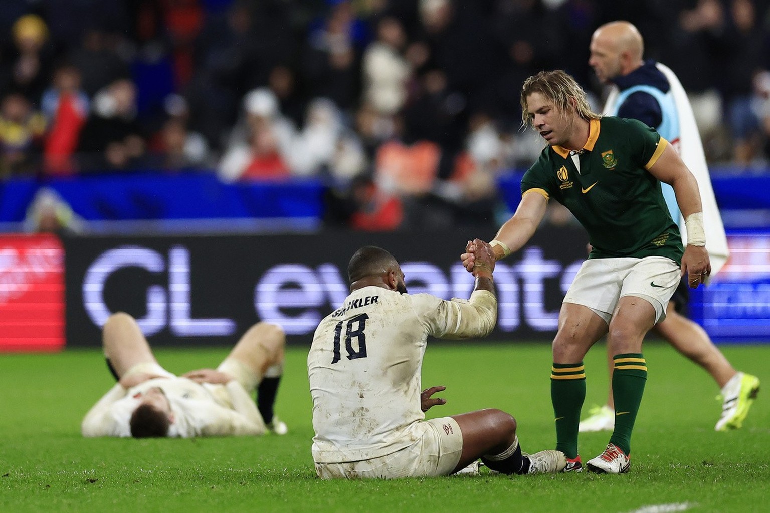 South Africa&#039;s Faf de Klerk helps England&#039;s Kyle Sinckler to stand up at the end of the Rugby World Cup semifinal match between England and South Africa at the Stade de France in Saint-Denis ...