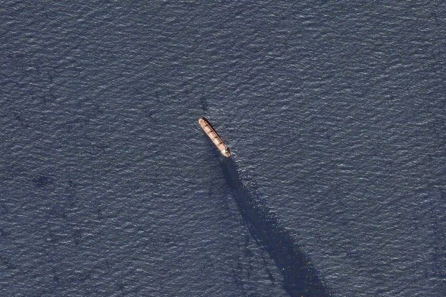 In this satellite image provided by Planet Labs, the Belize-flagged bulk carrier Rubymar is seen in the southern Red Sea near the Bay el-Mandeb Strait leaking oil after an attack by Yemen&#039;s Houth ...