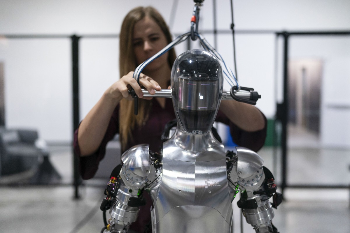 FILE - AI engineer Jenna Reher works on humanoid robot Figure 01 at Figure AI's test facility in Sunnyvale, Calif., Oct. 3, 2023. ChatGPT-maker OpenAI is looking to fuse its artificial intelligen ...