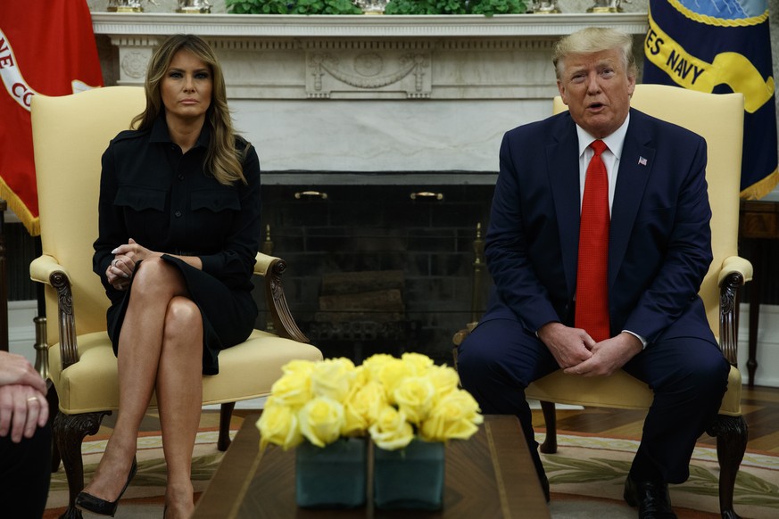 First lady Melania Trump listens as President Donald Trump talks about a plan to ban most flavored e-cigarettes, in the Oval Office of the White House, Wednesday, Sept. 11, 2019, in Washington. (AP Ph ...