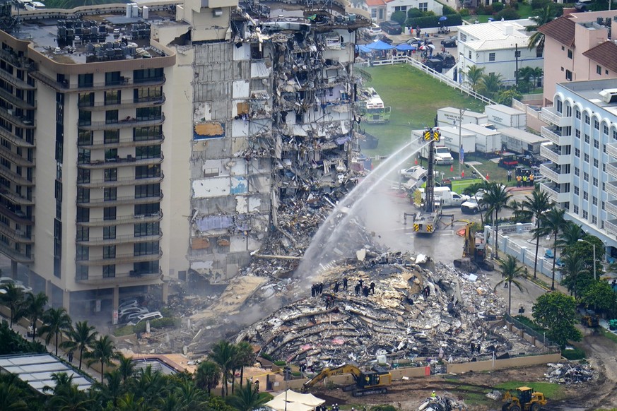 FILE - In this June 25, 2021, file photo, rescue personnel work at the remains of the Champlain Towers South condo building in Surfside, Fla. A private bidder is willing to offering up to $120 million ...