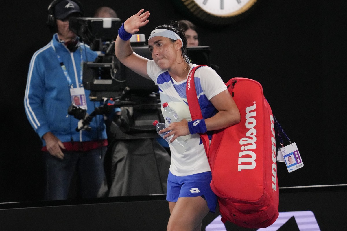 Ons Jabeur of Tunisia waves as she leaves Rod Laver Arena following her second round loss to Marketa Vondrousova of the Czech Republic at the Australian Open tennis championship in Melbourne, Australi ...