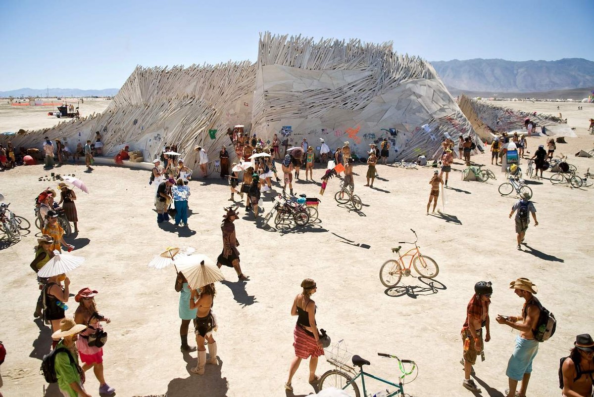 In this photo taken Wednesday, Sept. 1, 2010, Burners congregate around "The Temple of Flux," a spiritual place for many at Burning Man 2010 in Black Rock City, Nev. For one week out of the  ...