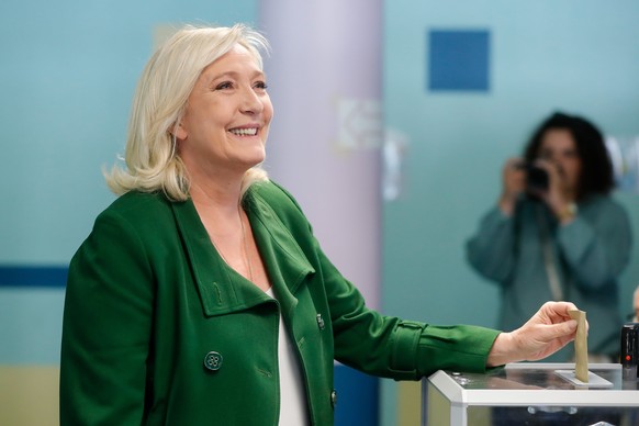 epa10009208 French far right candidate Marine Le Pen of the RN, Rassemblement National party (National Rally in French) casts her ballot in the first round of the legislative elections at a polling st ...