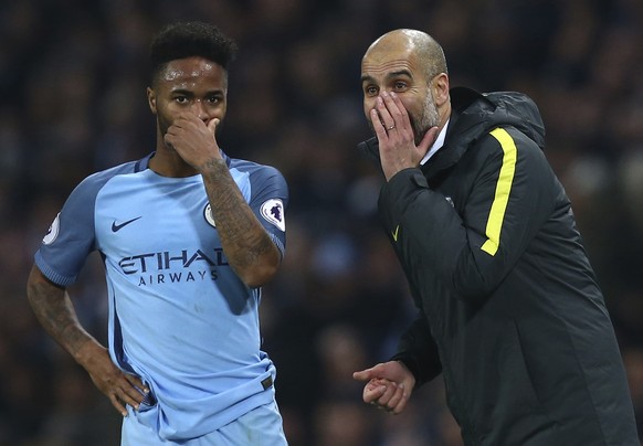 Manchester City manager Pep Guardiola and Manchester City's Raheem Sterling during the English Premier League soccer match between Manchester City and Arsenal at the Etihad Stadium in Manchester, England, Sunday, Dec. 18, 2016. (AP Photo/Dave Thompson)