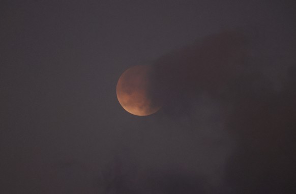 epa12792183 The Blood Moon during the total lunar eclipse in Havana, Cuba, 03 March 2026. A total lunar eclipse occurs when the Earth is positioned between the full moon and the sun, causing the full  ...
