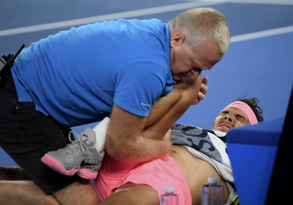 Spain&#039;s Rafael Nadal receives treatment from a trainer during his quarterfinal against Croatia&#039;s Marin Cilic at the Australian Open tennis championships in Melbourne, Australia, Tuesday, Jan ...