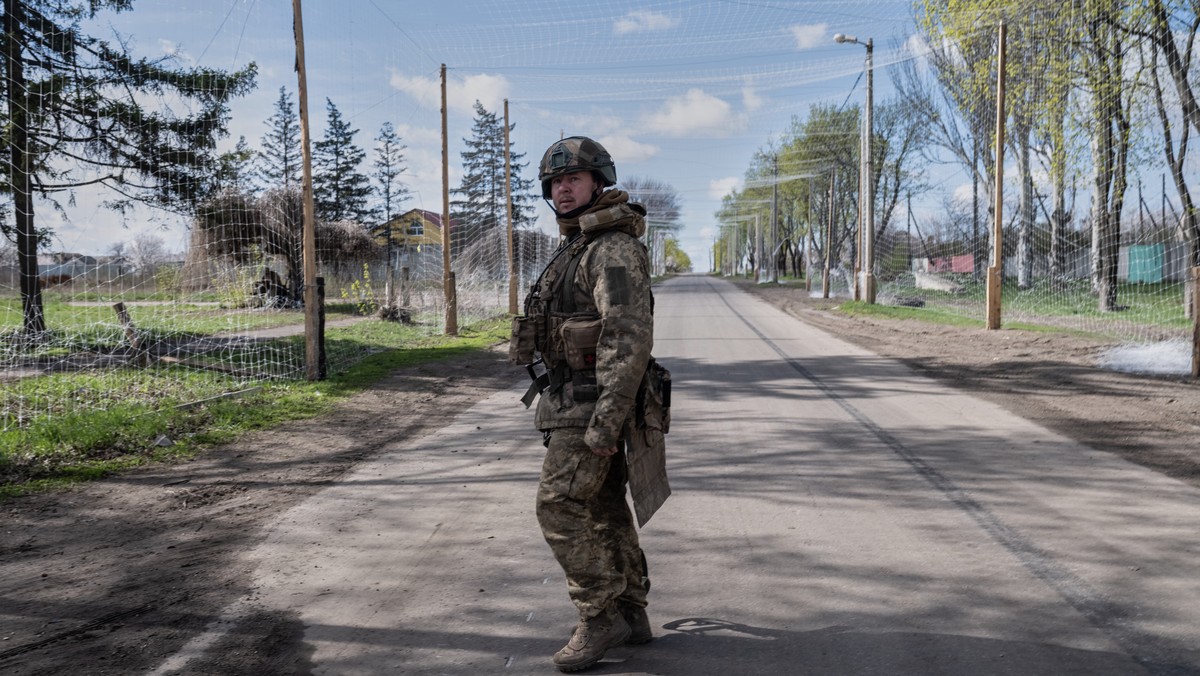 In this photo provided by Ukraine's 93rd Kholodnyi Yar Separate Mechanized Brigade press service, a serviceman stands under an anti-drone net in Druzhkivka, Donetsk region, Ukraine, Tuesday, Apri ...
