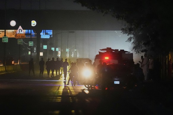 Pakistani police officers remove vehicles and people from the main entry of Nur Khan airbase following an Indian missile strike in Rawalpindi, Pakistan, Saturday, May 10, 2025. (AP Photo/Anjum Naveed) ...