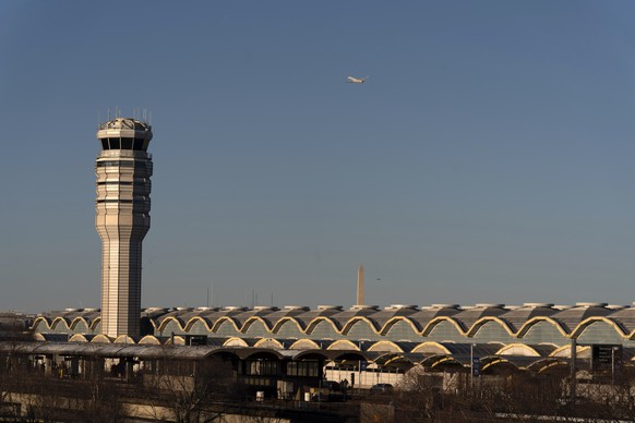 The air traffic control tower at Ronald Reagan Washington National Airport is pictured, Saturday, Feb. 1, 2025, in Arlington, Va., near the wreckage of a mid-air collision between a Black Hawk helicop ...
