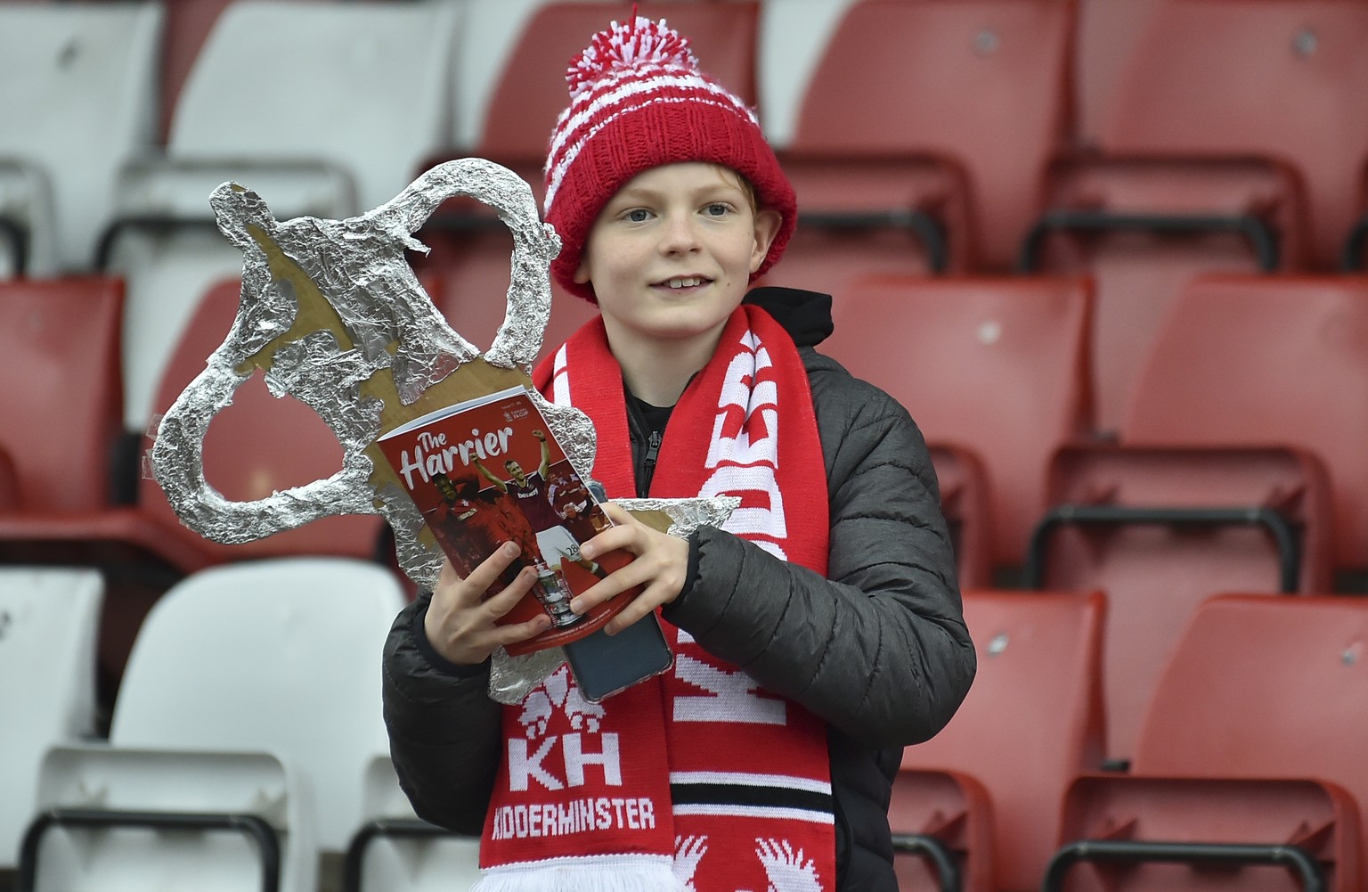 A young Kidderminster supporter holds a replica of the FA Cup before the English FA Cup fourth round soccer match between Kidderminster Harriers and West Ham United at Aggborough Stadium, Kidderminste ...
