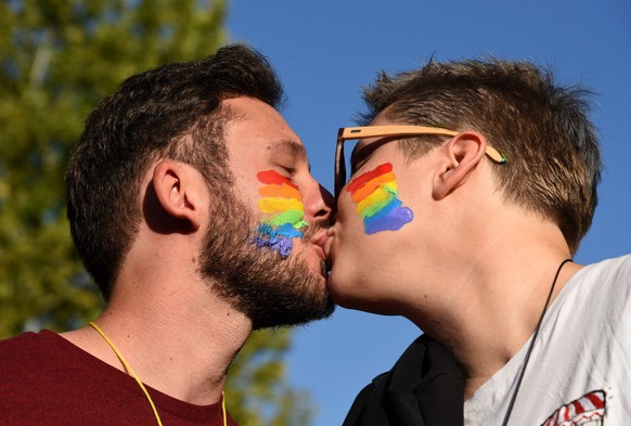 epa07859959 Two men kiss each other as they take part at the Lesbian, Gay, Bisexual and Transgender (LGBT) Pride march in Podgorica, Montenegro, 21 September 2019. Hundreds of gay activists and suppor ...