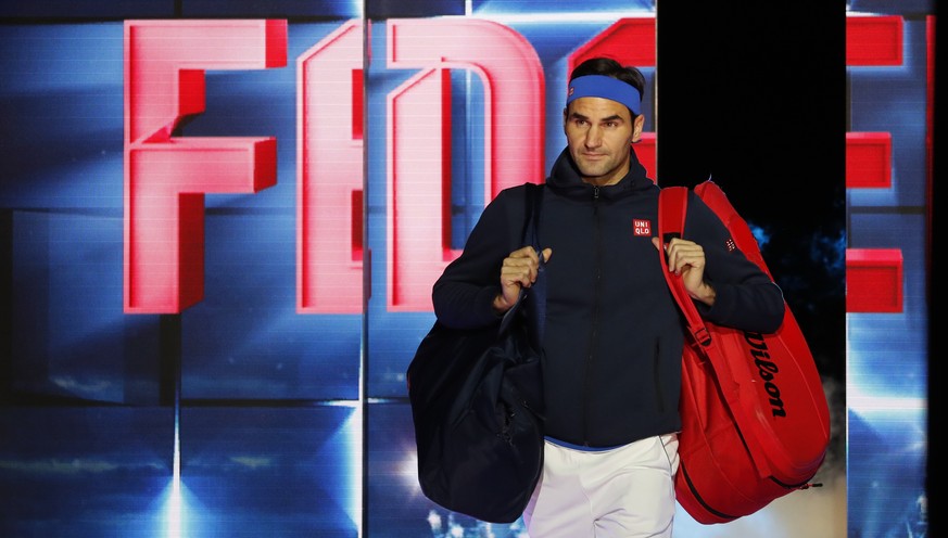 Roger Federer of Switzerland walks onto the court to play Dominic Thiem of Austria in their ATP World Tour Finals men&#039;s singles tennis match at the O2 arena in London, Tuesday, Nov. 13, 2018. (AP ...