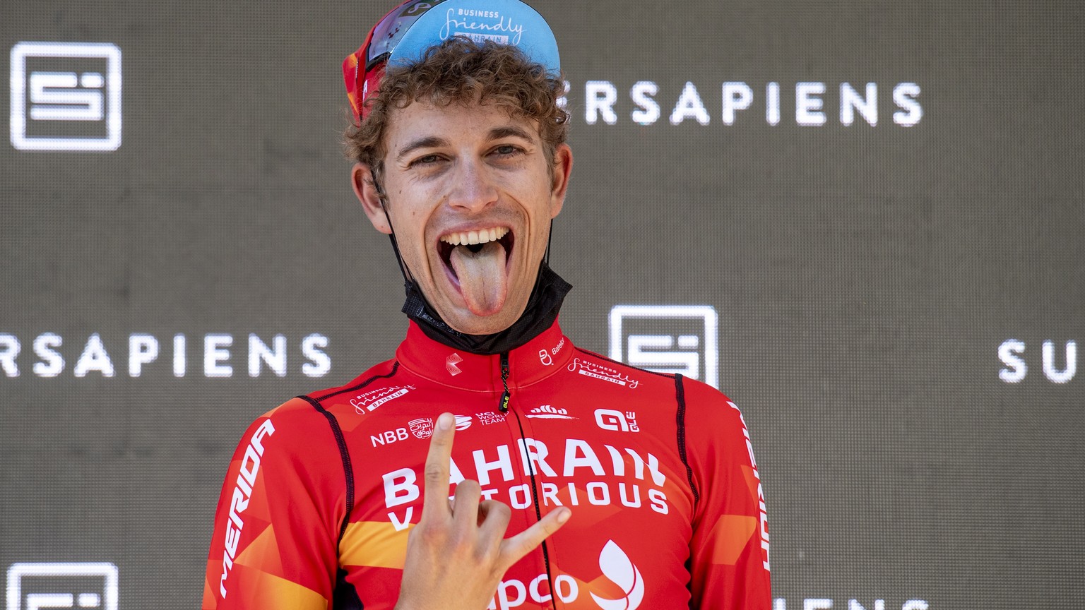 epa09267667 Gino Maeder from Switzerland of Bahrain Victorious reacts on the podium after the eigth and final stage, a 160 km race with start and finish in Andermatt, at the 84th Tour de Suisse UCI Pr ...