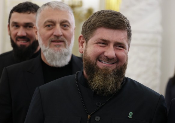 epa10215718 Chechnya&#039;s regional President Ramzan Kadyrov (R), Russian State Duma member Adam Delimkhanov (C) and Chechen Parliament Chairman Magomed Daudov (L) arrive for a ceremony to sign treat ...