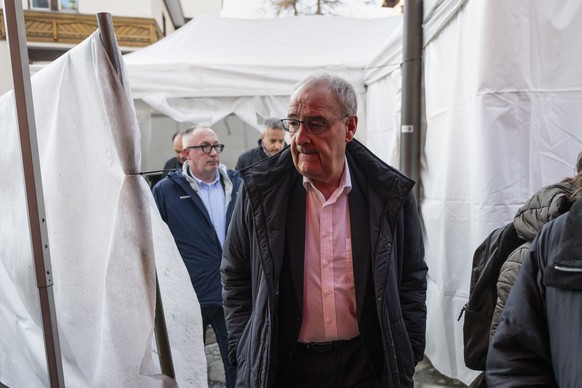 epa12620817 Swiss Federal President Guy Parmelin and the President of Crans-Montana, Nicolas Feraud, left, inspect the area where a fire of unidentified origin broke out at the "Le Constellation& ...