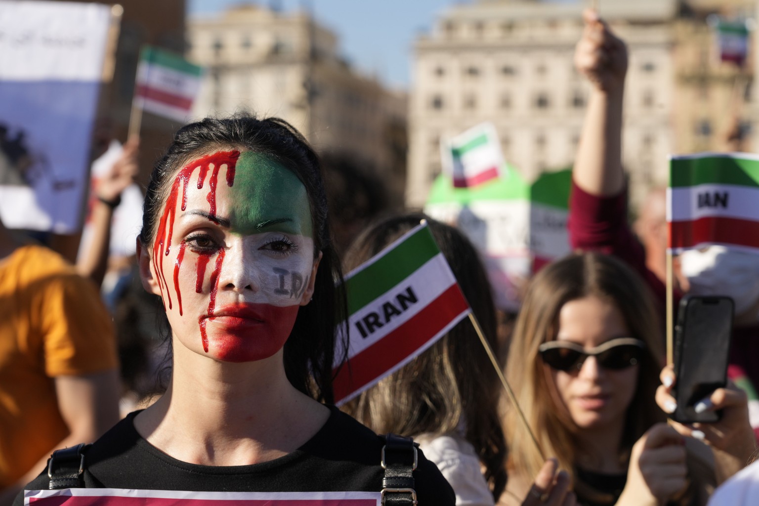 People stage a protest against the death of Mahsa Amini, a woman who died while in police custody in Iran, during a rally in central Rome, Saturday, Oct. 29, 2022. Amini, a 22-year-old woman was held  ...