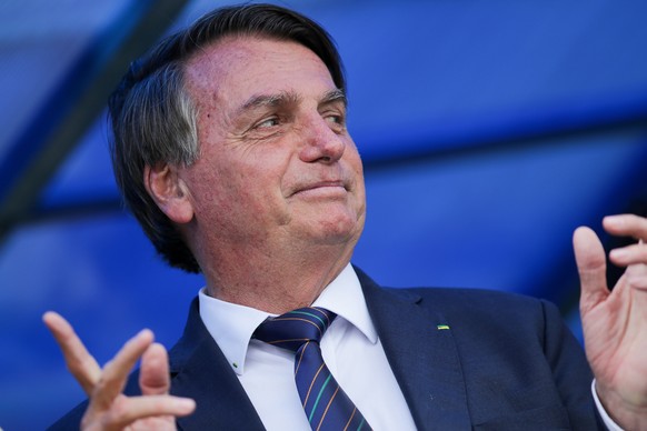 Brazilian President Jair Bolsonaro exits a convention center in Brasilia, Brazil, Tuesday, Nov. 30, 2021, after attending a ceremony where he officially joined the centrist Liberal Party. (AP Photo/Ra ...